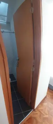 a wooden cabinet in a room with a tile floor at Casa Palermo Manizales in Manizales