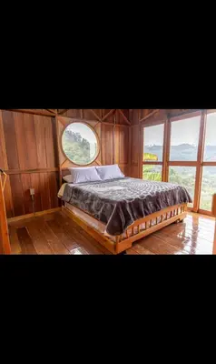 a bed in the center of a boat with a window at Finca La Arabia Jardín in Jardin