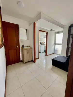 a living room with a bed and a door at Milano Manizales in Manizales