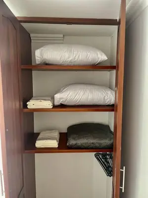 a wooden shelf with two pillows in a room at Milano Manizales in Manizales