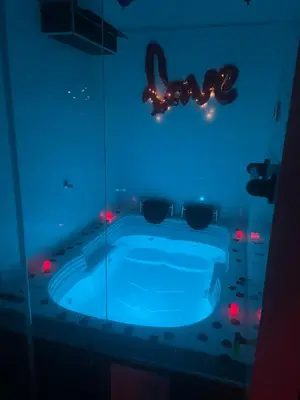 a bathroom with a blue tub with lights in it at Hotel ZT in Mariquita