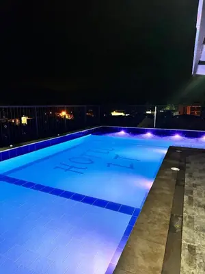 a large swimming pool with blue lights on a building at Hotel ZT in Mariquita