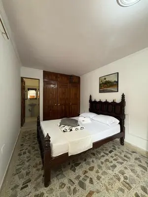 a bedroom with a large bed in a room at Casa Hotel Piedra del Sol in Betania