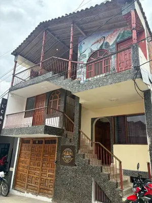 a building with a mural on the side of it at Casa Hotel Piedra del Sol in Betania