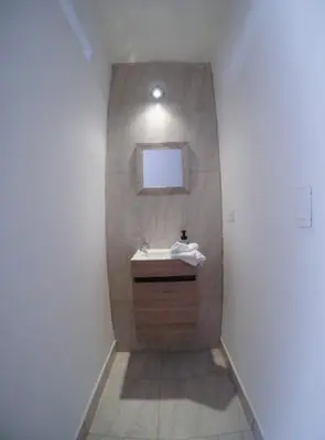 a bathroom with a sink and a mirror at Casa Hotel Piedra del Sol in Betania