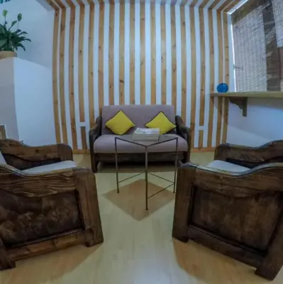 a living room with a couch and two chairs at Casa Hotel Piedra del Sol in Betania