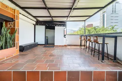a patio with chairs and a bar with a view at 3 Story Penthouse with 2 parking spaces in Laureles in Medellín