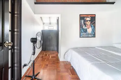 a room with a bed and a fan and a picture at 3 Story Penthouse with 2 parking spaces in Laureles in Medellín