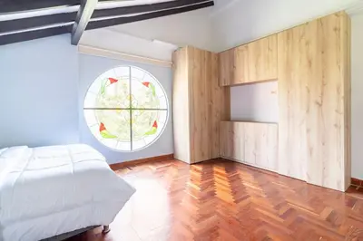 a bedroom with a bed and a round window at 3 Story Penthouse with 2 parking spaces in Laureles in Medellín