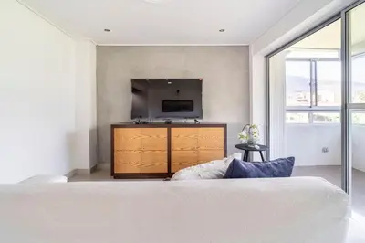 a bedroom with a bed and a large window at 3 Story Penthouse with 2 parking spaces in Laureles in Medellín