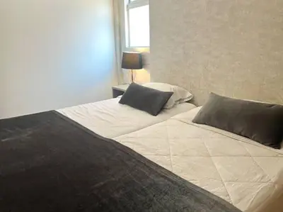 a bedroom with two beds with pillows and a window at Impecable y lujoso apartamento para una estadía unica in Medellín