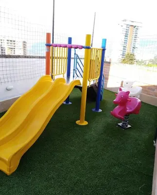 a playground with a yellow slide and a toy pig at Impecable y lujoso apartamento para una estadía unica in Medellín