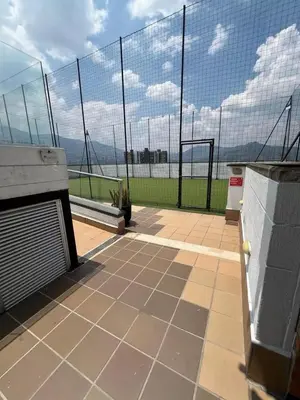 a view of a tennis court with a fence at Impecable y lujoso apartamento para una estadía unica in Medellín