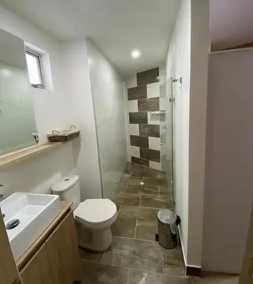 a bathroom with a toilet and a sink and a shower at Impecable y lujoso apartamento para una estadía unica in Medellín