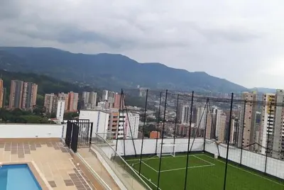 a tennis court on the roof of a building at Impecable y lujoso apartamento para una estadía unica in Medellín