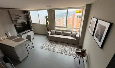a living room with a couch and a table at Apartment near Provenza by Hoost in Medellín