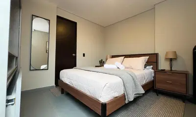 a bedroom with a large bed and a mirror at Apartment near Provenza by Hoost in Medellín