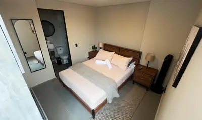 a bedroom with a bed and a large mirror at Apartment near Provenza by Hoost in Medellín
