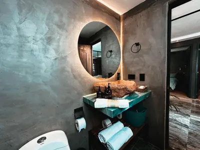 a bathroom with a sink and a mirror at LUXURY PALACE POBLADO MANILA in El Poblado