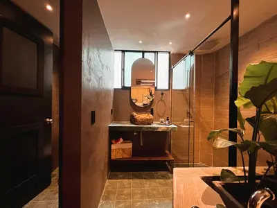 a bathroom with a shower with a sink and a mirror at LUXURY PALACE POBLADO MANILA in El Poblado