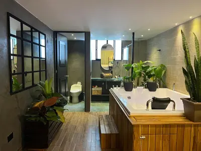 a bathroom with a sink and a tub with plants at LUXURY PALACE POBLADO MANILA in El Poblado