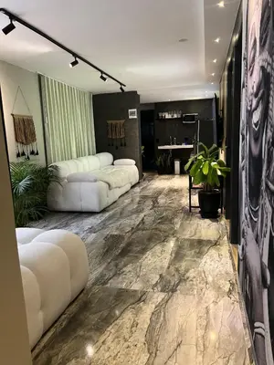 a living room with white furniture and a marble floor at LUXURY PALACE POBLADO MANILA in El Poblado