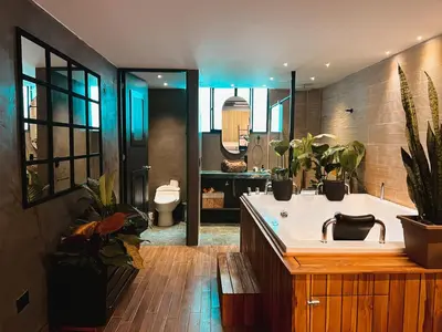 a bathroom with a tub with plants in it at LUXURY PALACE POBLADO MANILA in El Poblado