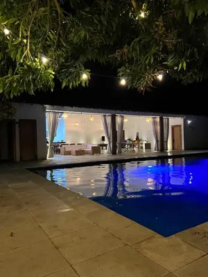 a swimming pool in a house at night at Quinta San Felipe in Manizales
