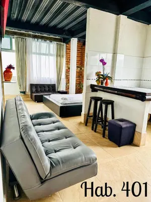 a living room with a couch and a table at Villa Tikuna in Mariquita