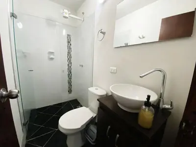 a bathroom with a sink and a toilet and a shower at Aparta Suites Rosales in Medellín