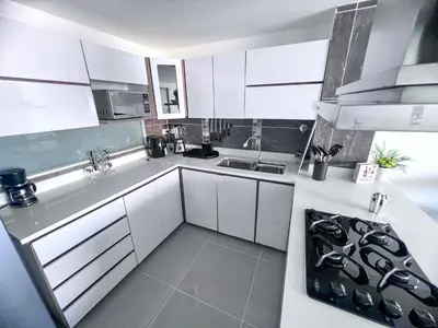 a kitchen with white cabinets and a sink at Medellin's Coolest neighborhood in Medellín