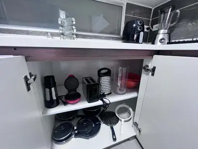 a cupboard with dishes and other kitchen items in it at Medellin's Coolest neighborhood in Medellín