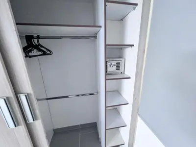 a walk in closet with a white door and shelves at Medellin's Coolest neighborhood in Medellín