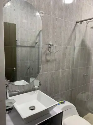 a bathroom with a sink and a toilet and a mirror at Apartamento de descanso in La Dorada