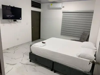 a hospital room with a bed and a flat screen tv at Apartamento de descanso in La Dorada