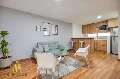 a living room with a couch and a table at Apartamento de lujo laureles con Aire y hamaca 200 in Medellín