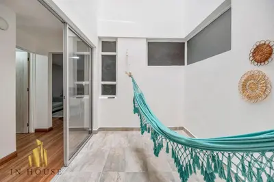 a hammock in the middle of a room at Apartamento de lujo laureles con Aire y hamaca 200 in Medellín