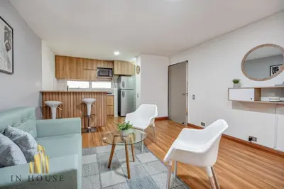 a living room with a couch and a table at Apartamento de lujo laureles con Aire y hamaca 200 in Medellín