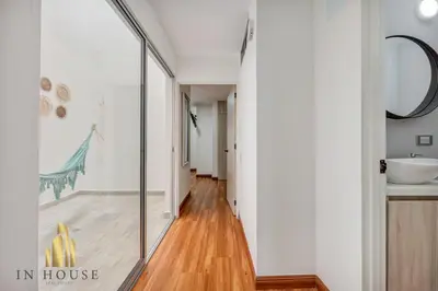 a hallway with a glass door in a house at Apartamento de lujo laureles con Aire y hamaca 200 in Medellín