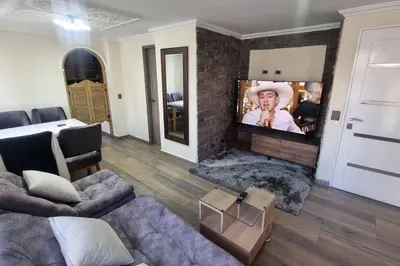 a living room with a couch and a flat screen tv at apto a 3 cuadras del estadio espectacular in Medellín