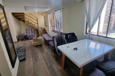 a living room with a table and a couch at apto a 3 cuadras del estadio espectacular in Medellín