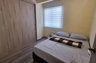 a bed in a room with a window and a bed sidx sidx sidx at apto a 3 cuadras del estadio espectacular in Medellín