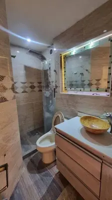 a bathroom with a toilet and a sink with a bowl at apto a 3 cuadras del estadio espectacular in Medellín