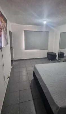 a white room with a bed and a window at hermosa casa para tour comuna 13 in Medellín