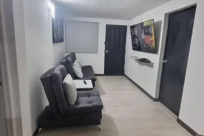 a living room with a couch and a chair at hermosa casa para tour comuna 13 in Medellín