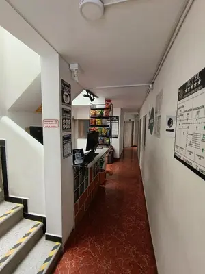 a hallway of a building with stairs and a desk at Hotel Confort Boutique in Rionegro