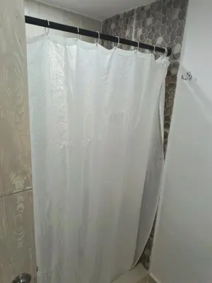 a shower with a white shower curtain in a bathroom at Hotel Confort Boutique in Rionegro