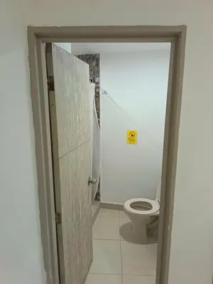 a bathroom with a toilet and an open door at Hotel Confort Boutique in Rionegro