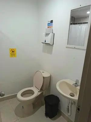 a bathroom with a toilet and a sink at Hotel Confort Boutique in Rionegro