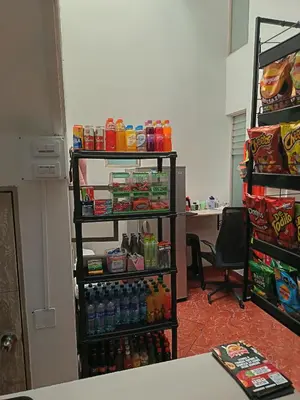 an office with a shelf filled with drinks and snacks at Hotel Confort Boutique in Rionegro